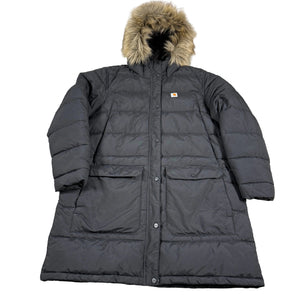 Black winter coat with fur hood on a wooden floor