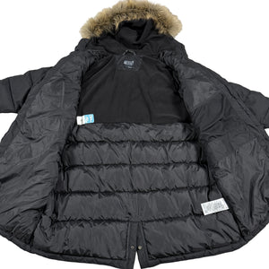 Black puffer jacket with fur hood on a wooden floor